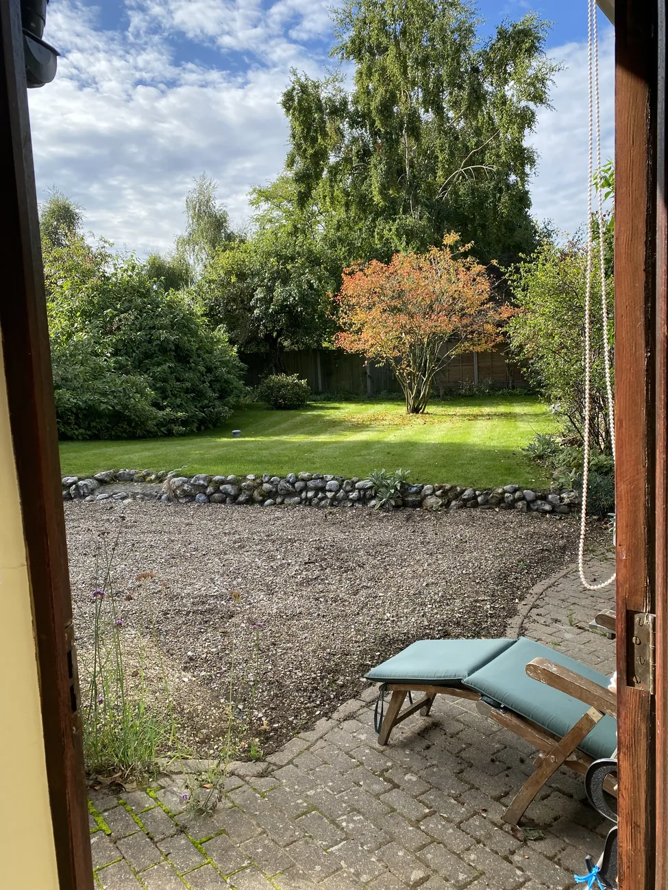 A view from the retreat cottage doorway across the patio and garden